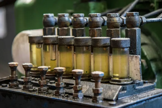 A row of oil bottles sitting on top of a machine